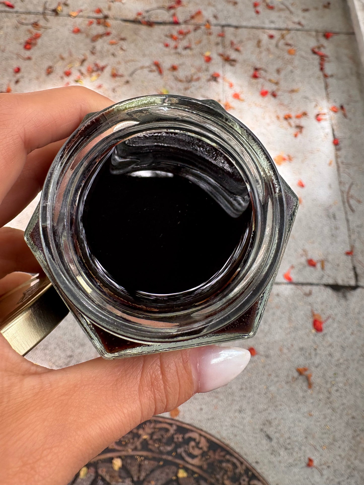 This picture shows the Herbal infused Syrup finished product. Dark in color from the Elderberries and thick consistency like honey.